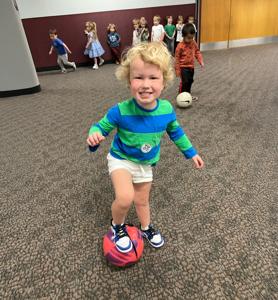 little boy posing with soccer ball