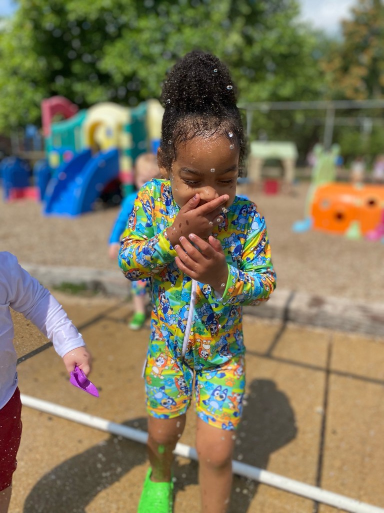 Girl playing in water on the playground
